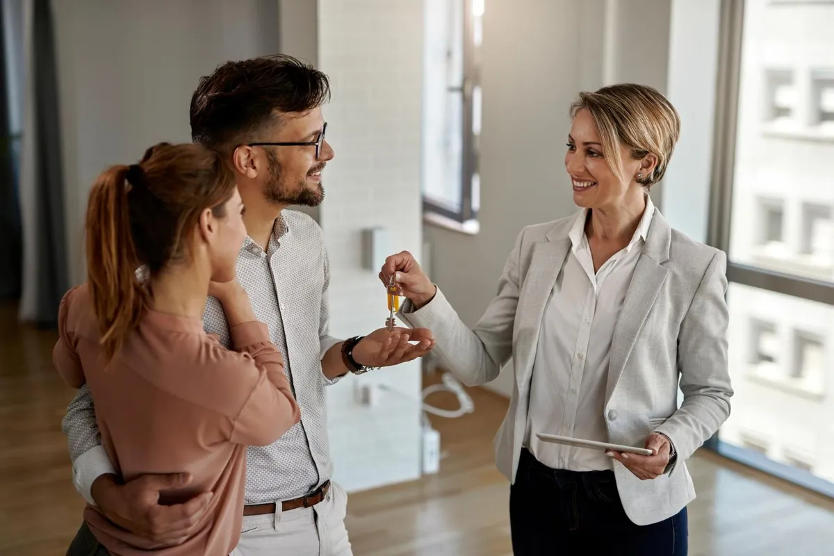 Estate agent showing a property to potential buyers
