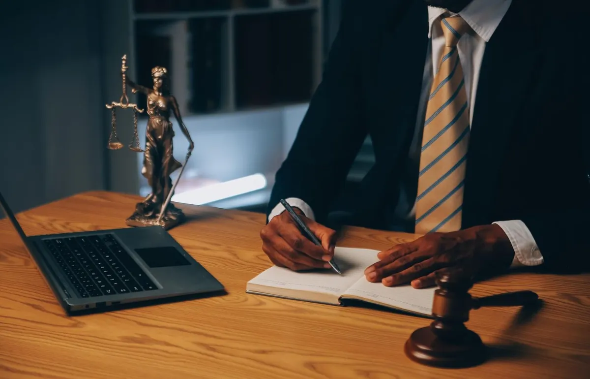 Solicitor meeting a client across a desk in a law office